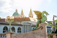 Na fotografiji je zmajski most in v ozadju mesto Ljubljana.